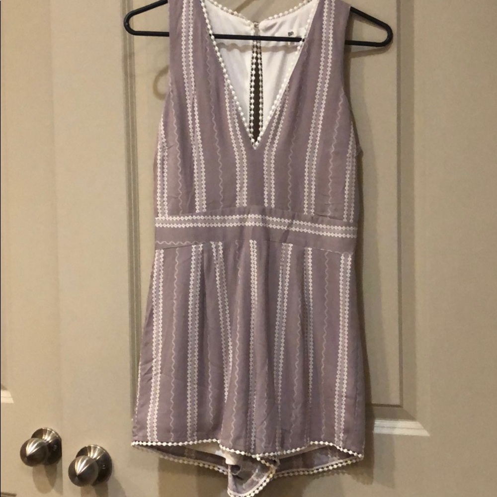 Purple Romper with White Details.
